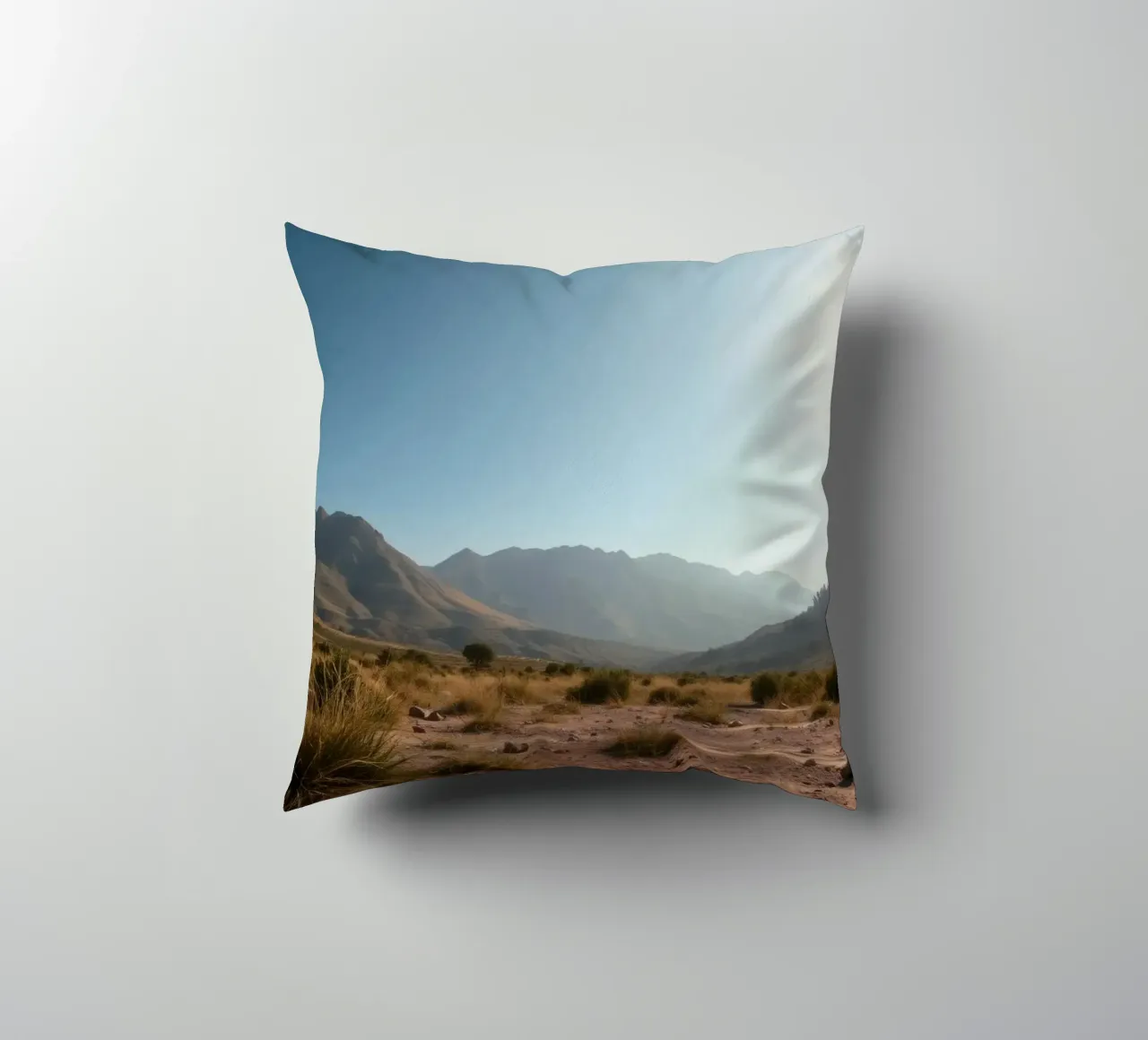 Expansive landscape view of rugged mountains & golden grass decorative cushion by DesignDoodle