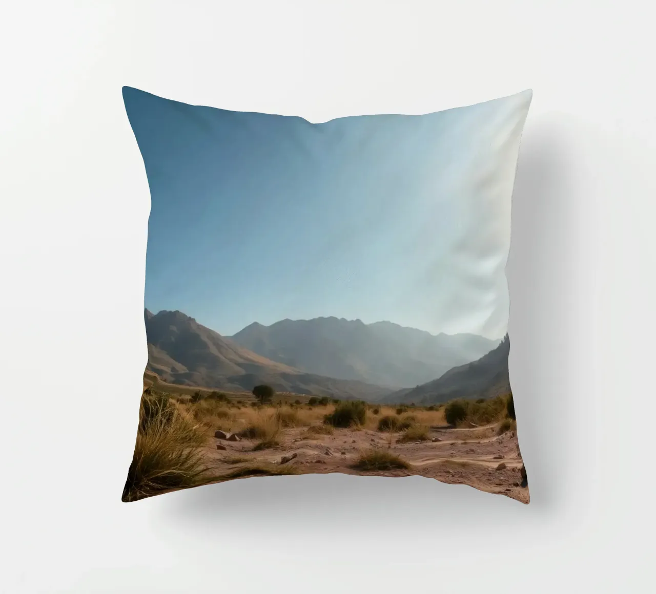 Expansive landscape view of rugged mountains & golden grass decorative cushion by DesignDoodle