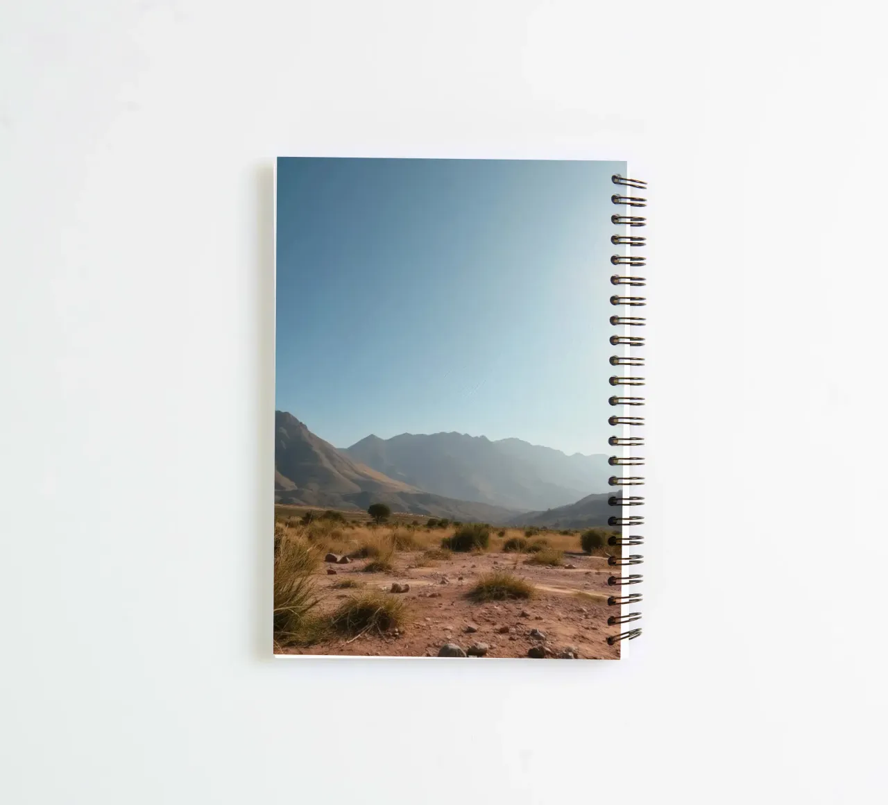 Expansive landscape view of rugged mountains & golden grass spiral notebook by DesignDoodle