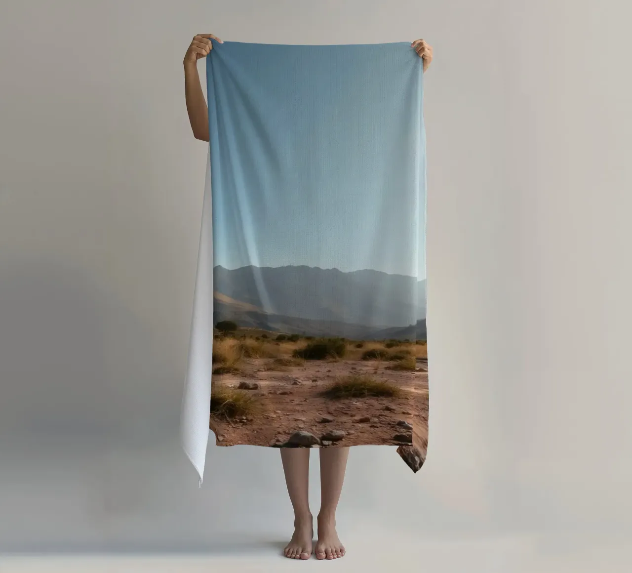 Expansive landscape view of rugged mountains & golden grass beach towel by DesignDoodle