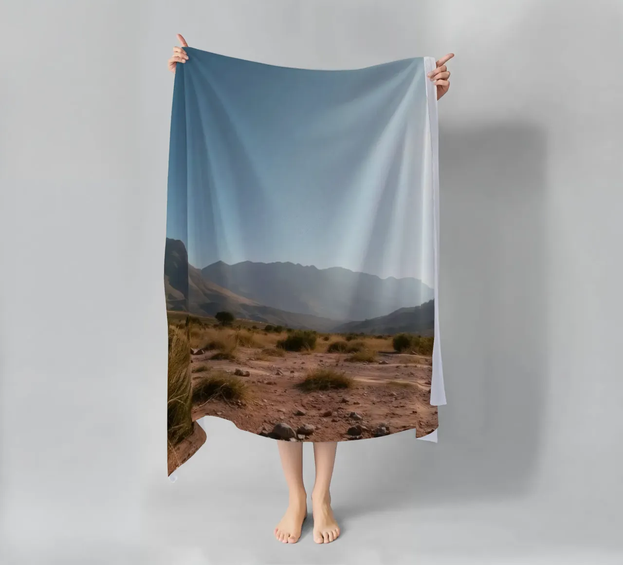 Expansive landscape view of rugged mountains & golden grass beach towel by DesignDoodle