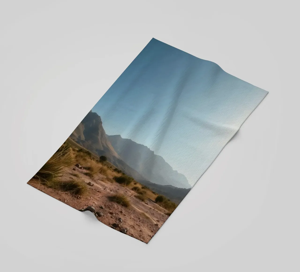 Expansive landscape view of rugged mountains & golden grass beach towel by DesignDoodle