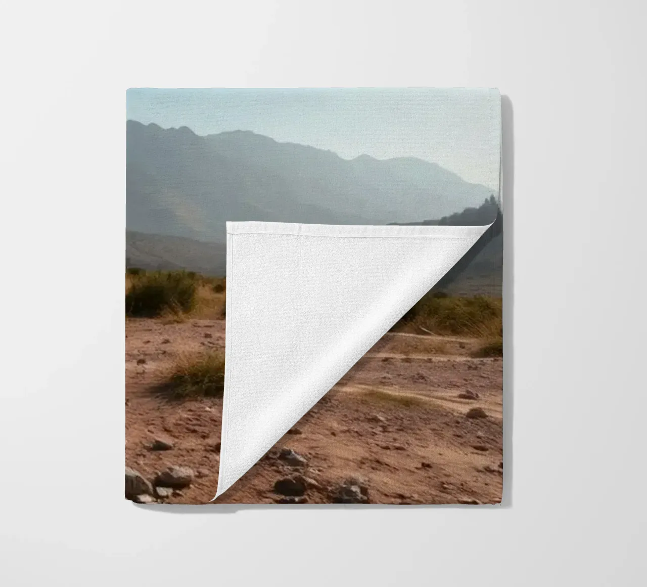 Expansive landscape view of rugged mountains & golden grass beach towel by DesignDoodle