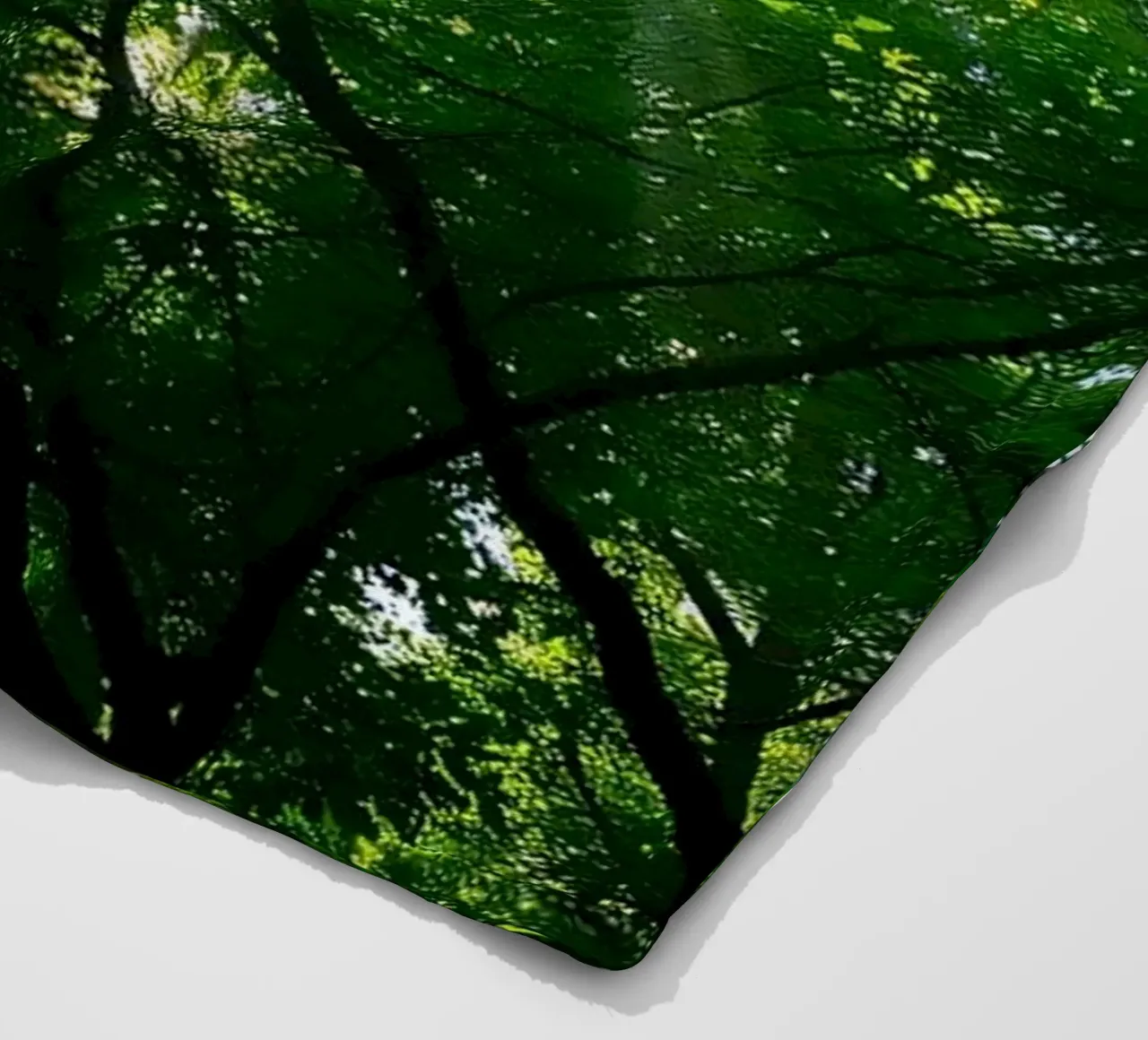 Sunlight filtering through dense green trees in calm fleece blanket by DesignDoodle