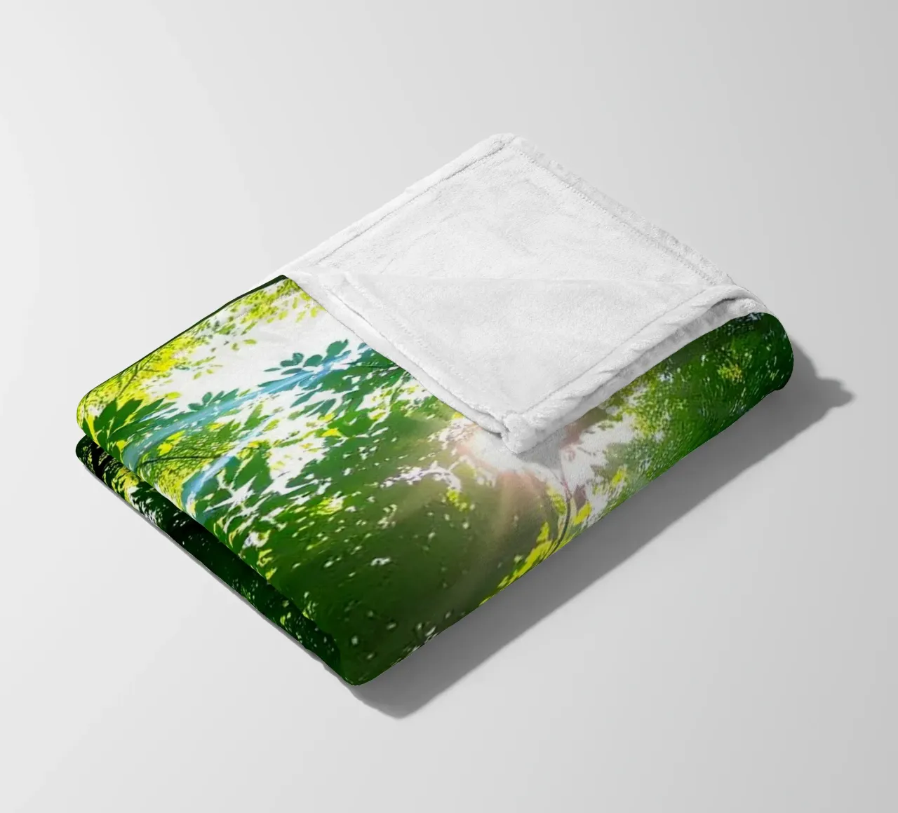 Sunlight filtering through dense green trees in calm fleece blanket by DesignDoodle