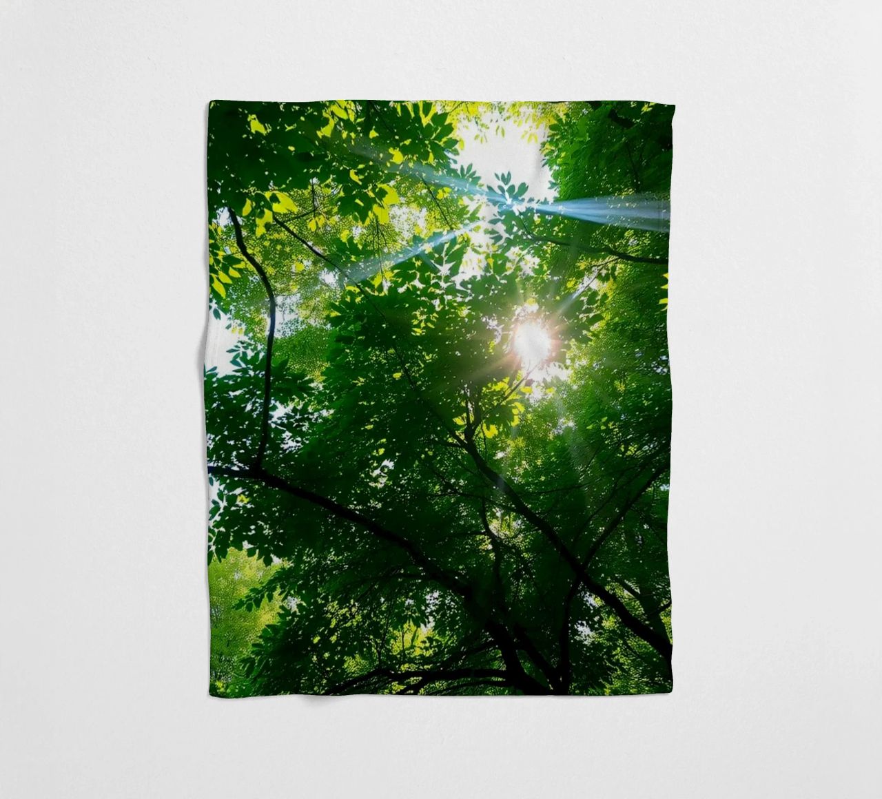Sunlight filtering through dense green trees in calm fleece blanket by DesignDoodle