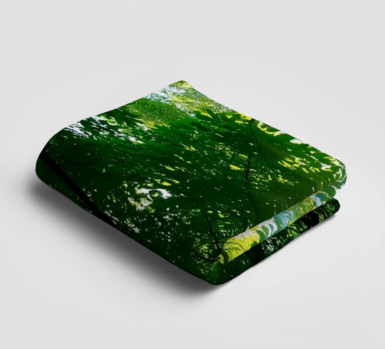 Sunlight filtering through dense green trees in calm towel by DesignDoodle