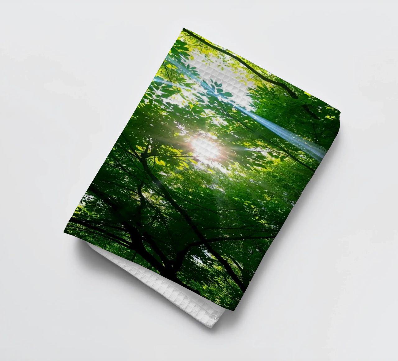 Sunlight filtering through dense green trees in calm tea towel by DesignDoodle