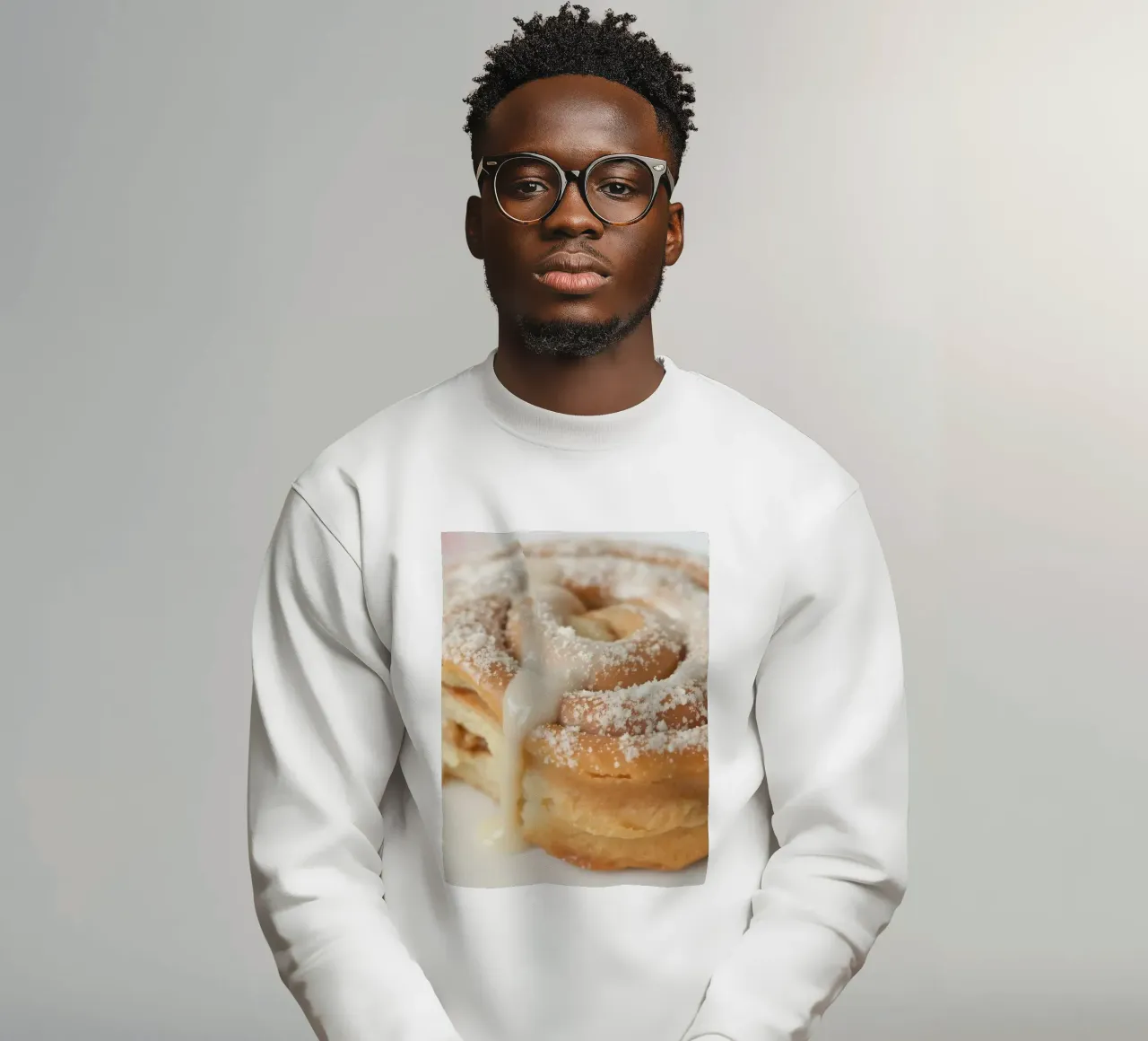 Warm cinnamon roll with cream icing and powdered sugar on a sweatshirt by DesignDoodle