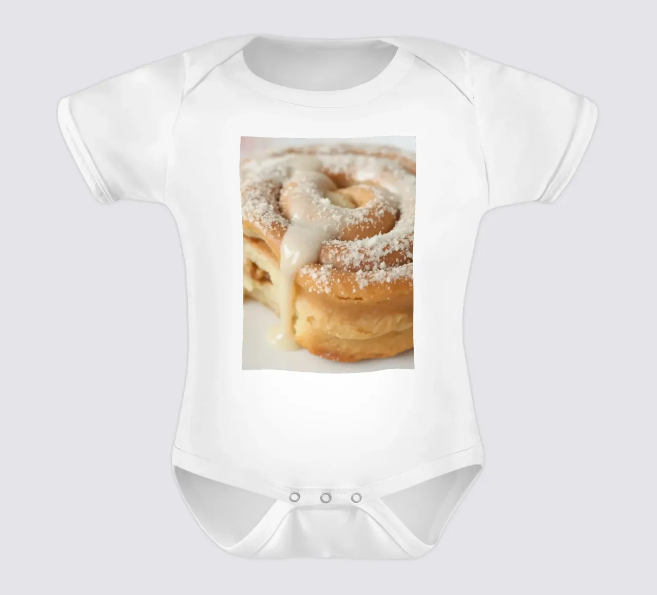 Warm cinnamon roll with cream icing and powdered sugar on a short-sleeve baby romper by DesignDoodle