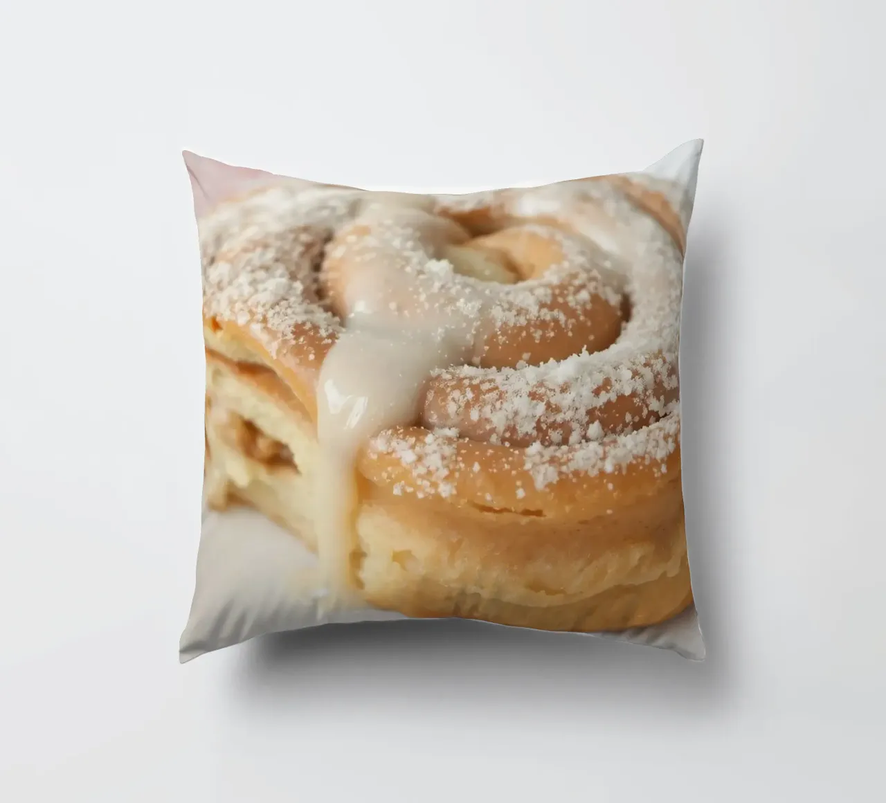 Warm cinnamon roll with cream icing and powdered sugar on a decorative cushion by DesignDoodle