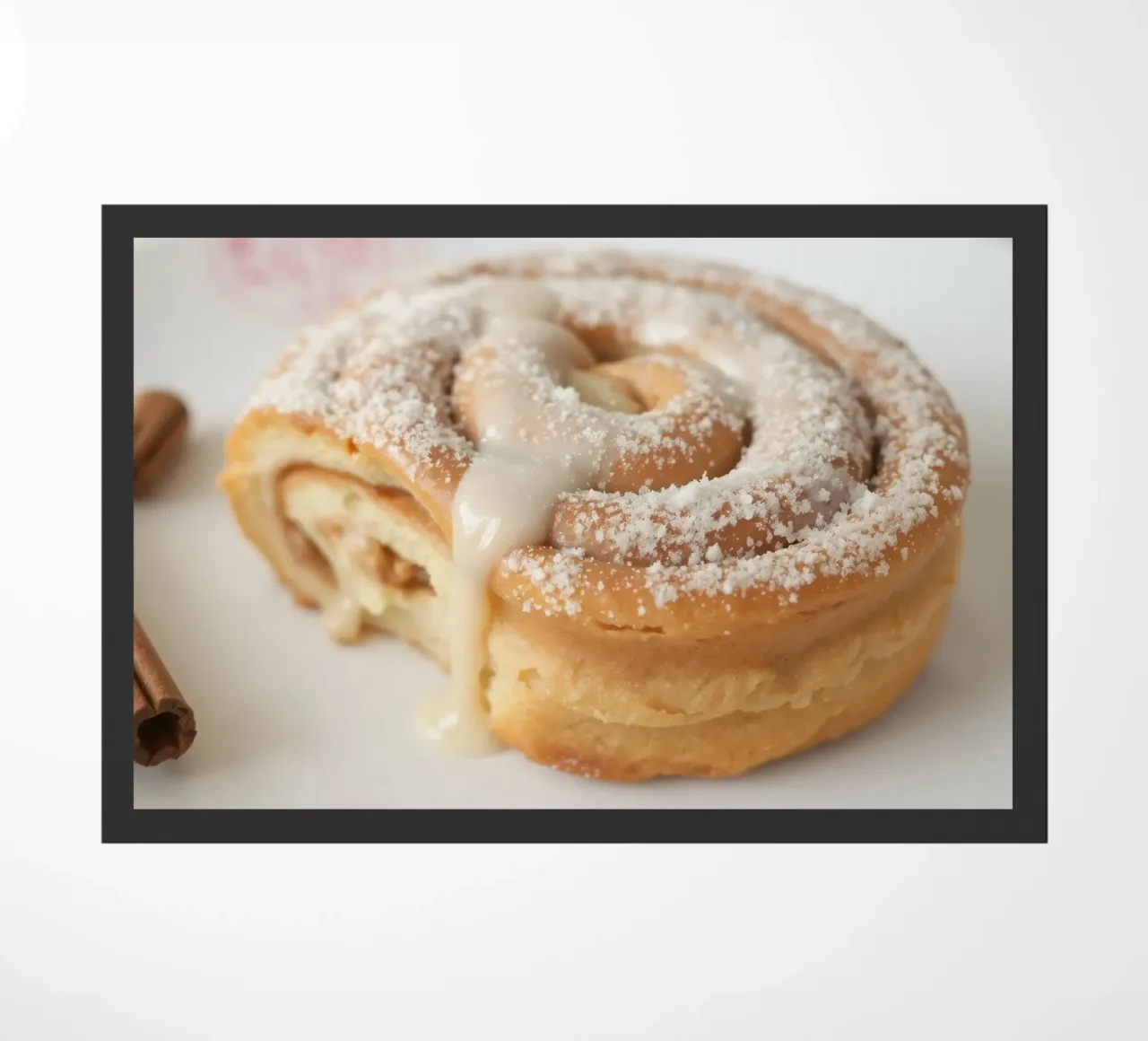 Warm cinnamon roll with cream icing and powdered sugar on a doormat by DesignDoodle