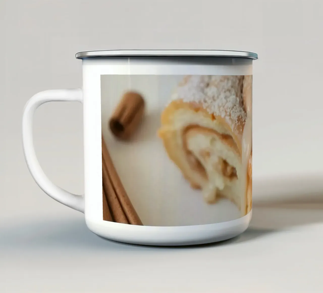Warm cinnamon roll with cream icing and powdered sugar on a enamel mug by DesignDoodle