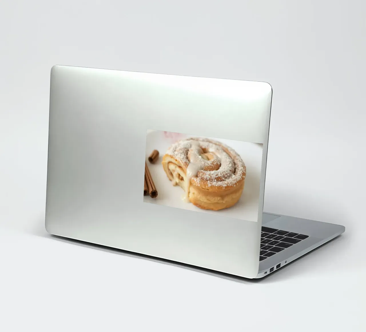 Warm cinnamon roll with cream icing and powdered sugar on a sticker by DesignDoodle