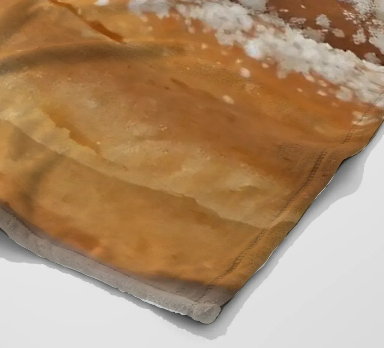 Warm cinnamon roll with cream icing and powdered sugar on a fleece blanket by DesignDoodle