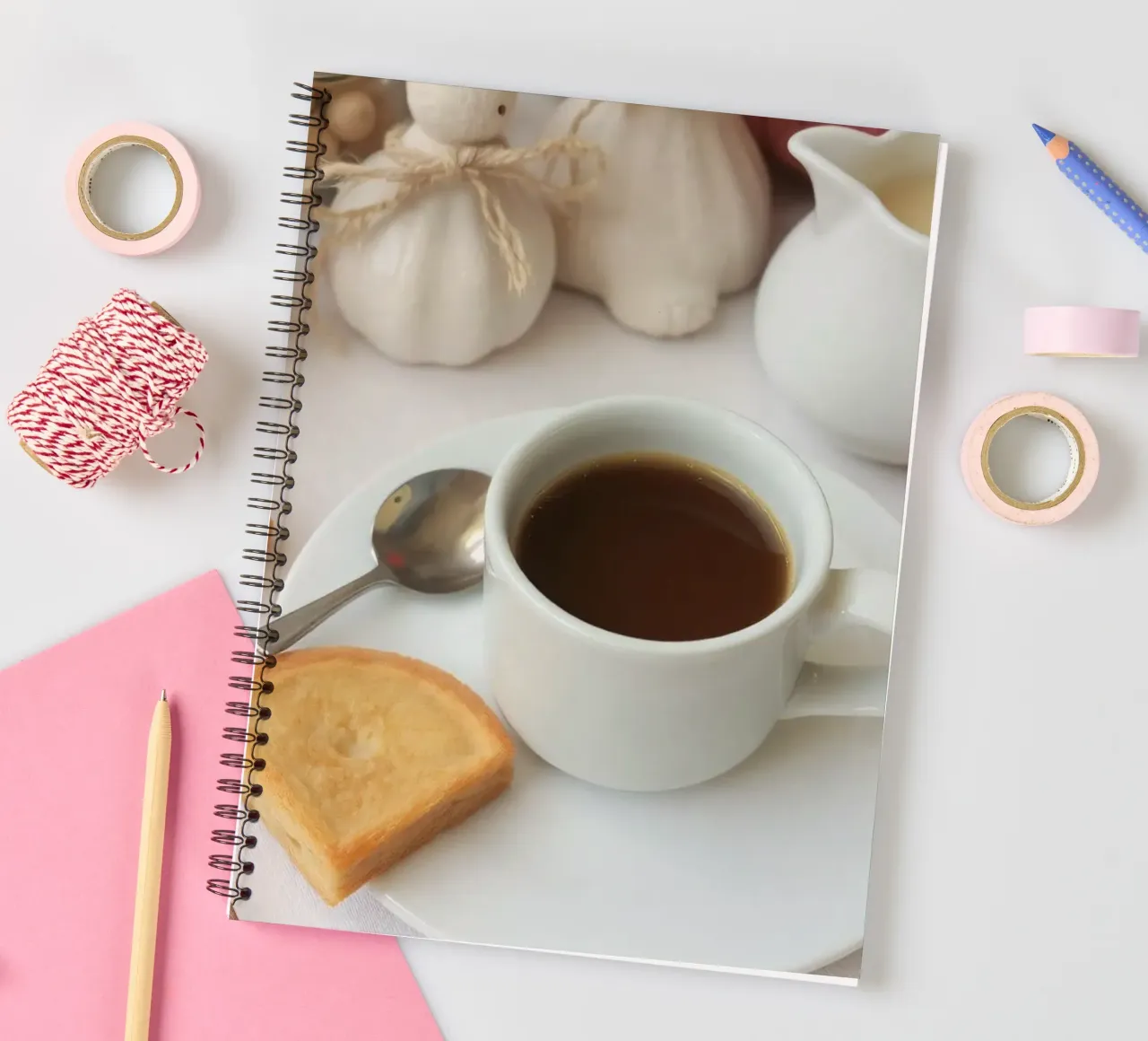 Cozy coffee and cookies setup on a table with warm colors an spiral notebook by DesignDoodle