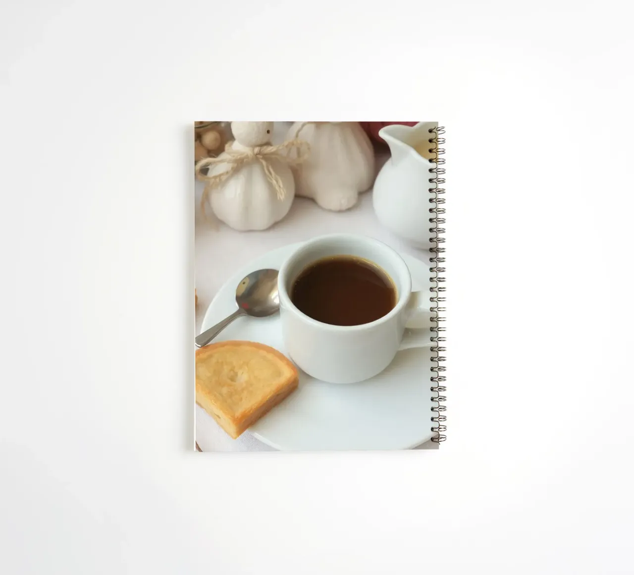 Cozy coffee and cookies setup on a table with warm colors an spiral notebook by DesignDoodle