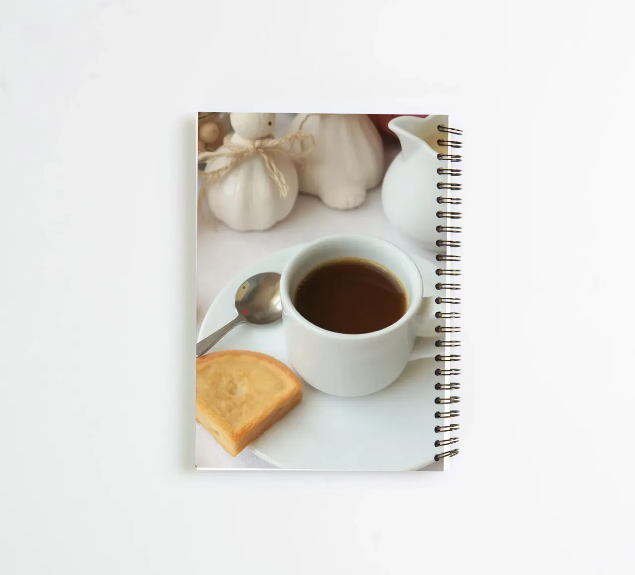 Cozy coffee and cookies setup on a table with warm colors an spiral notebook by DesignDoodle