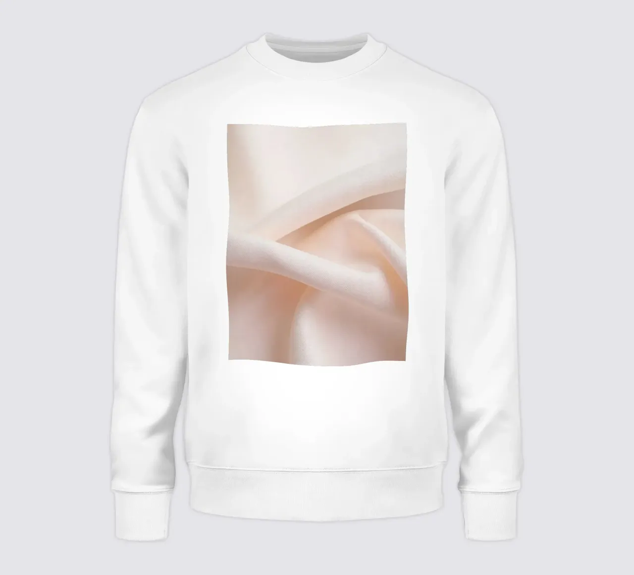 Soft beige fabric draped and folded on a surface sweatshirt by DesignDoodle