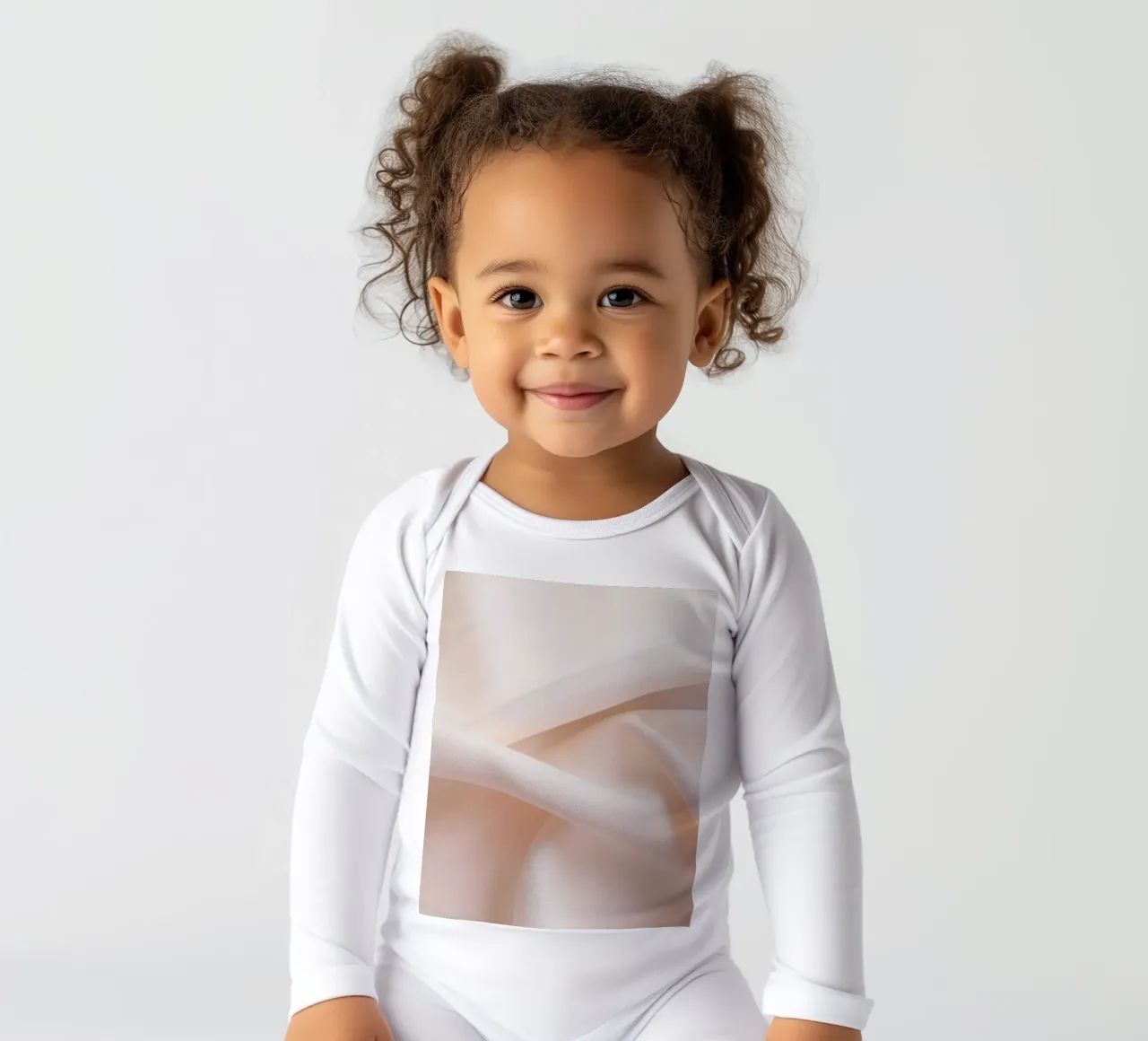Soft beige fabric draped and folded on a surface long-sleeve baby romper by DesignDoodle