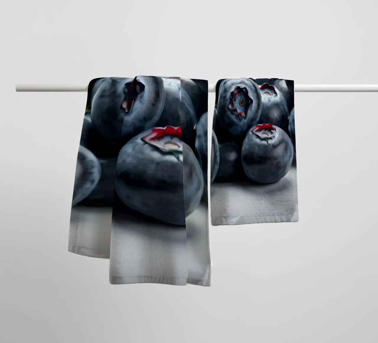 Fresh blueberries arranged neatly on a reflective surface towel by DesignDoodle