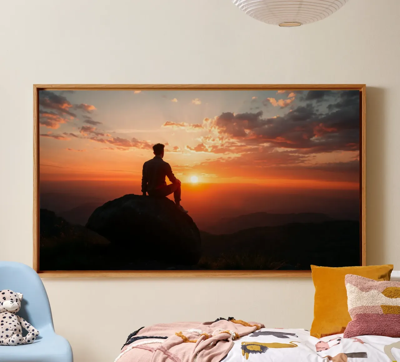 Person sits on a rock watching sunset over a mountains canvas with Floater frame by DesignDoodle