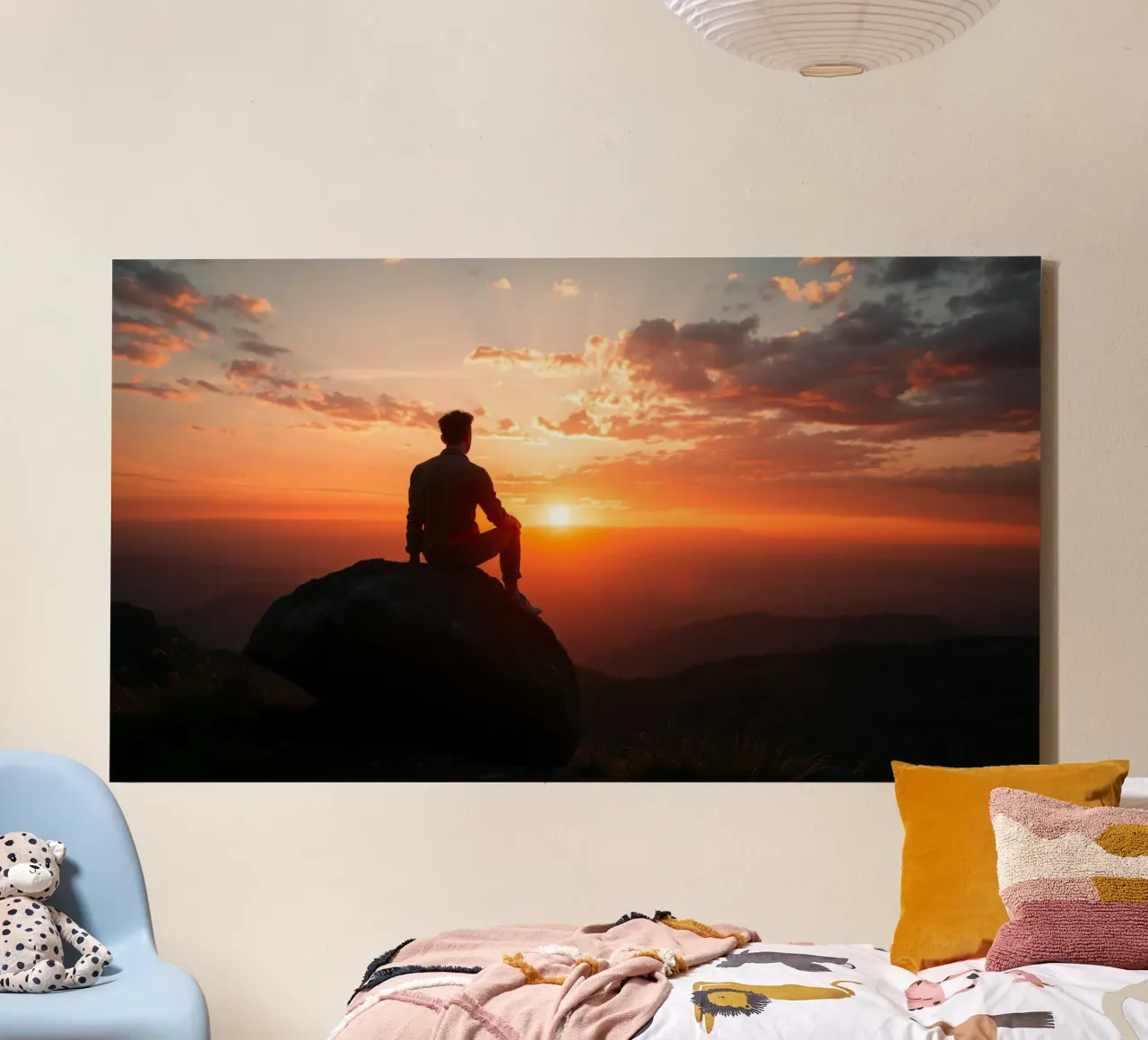 Person sits on a rock watching sunset over a mountains canvas with Floater frame by DesignDoodle