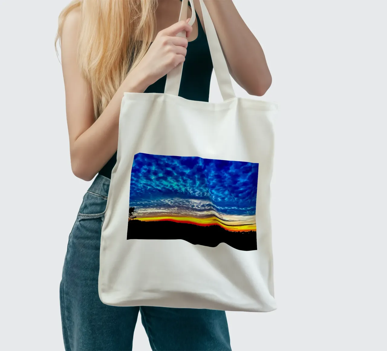 Sunset with dark blue clouds tote bag by RealLifeMoments