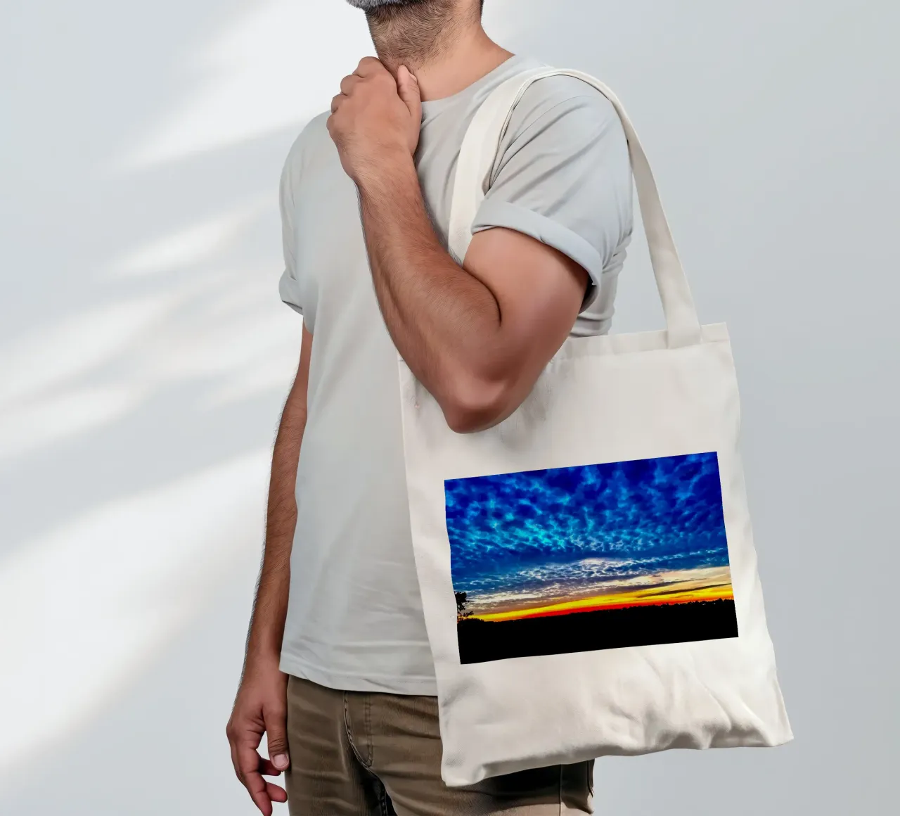 Sunset with dark blue clouds tote bag by RealLifeMoments