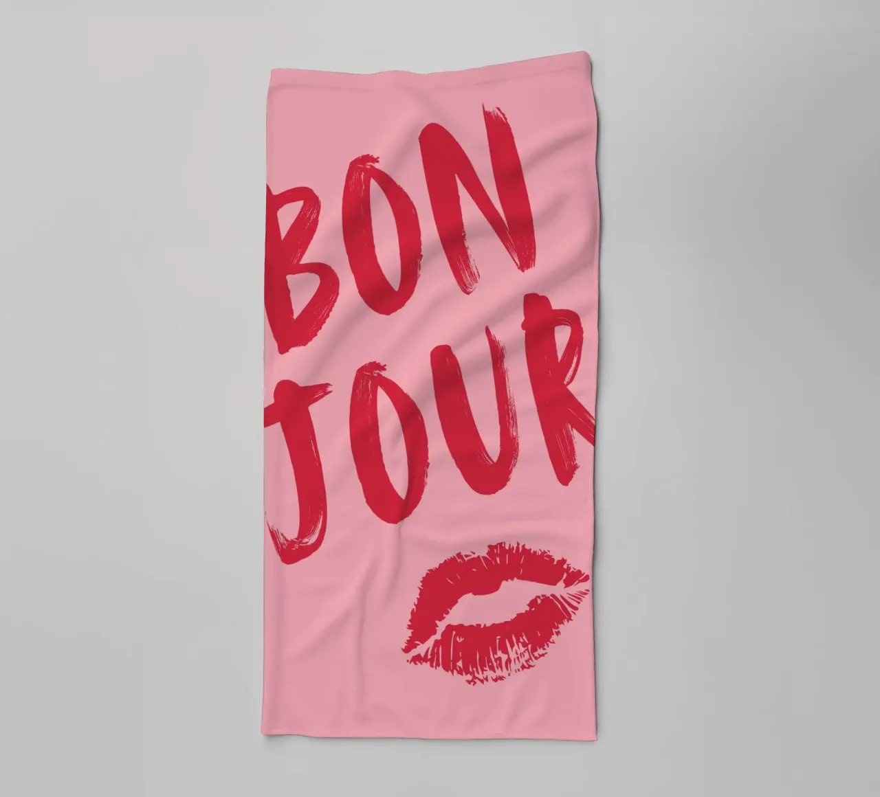 Testo "Bonjour" rosso in grassetto con stampa a labbro su sfondo rosa asciugamano da bagno da pdigitalprints