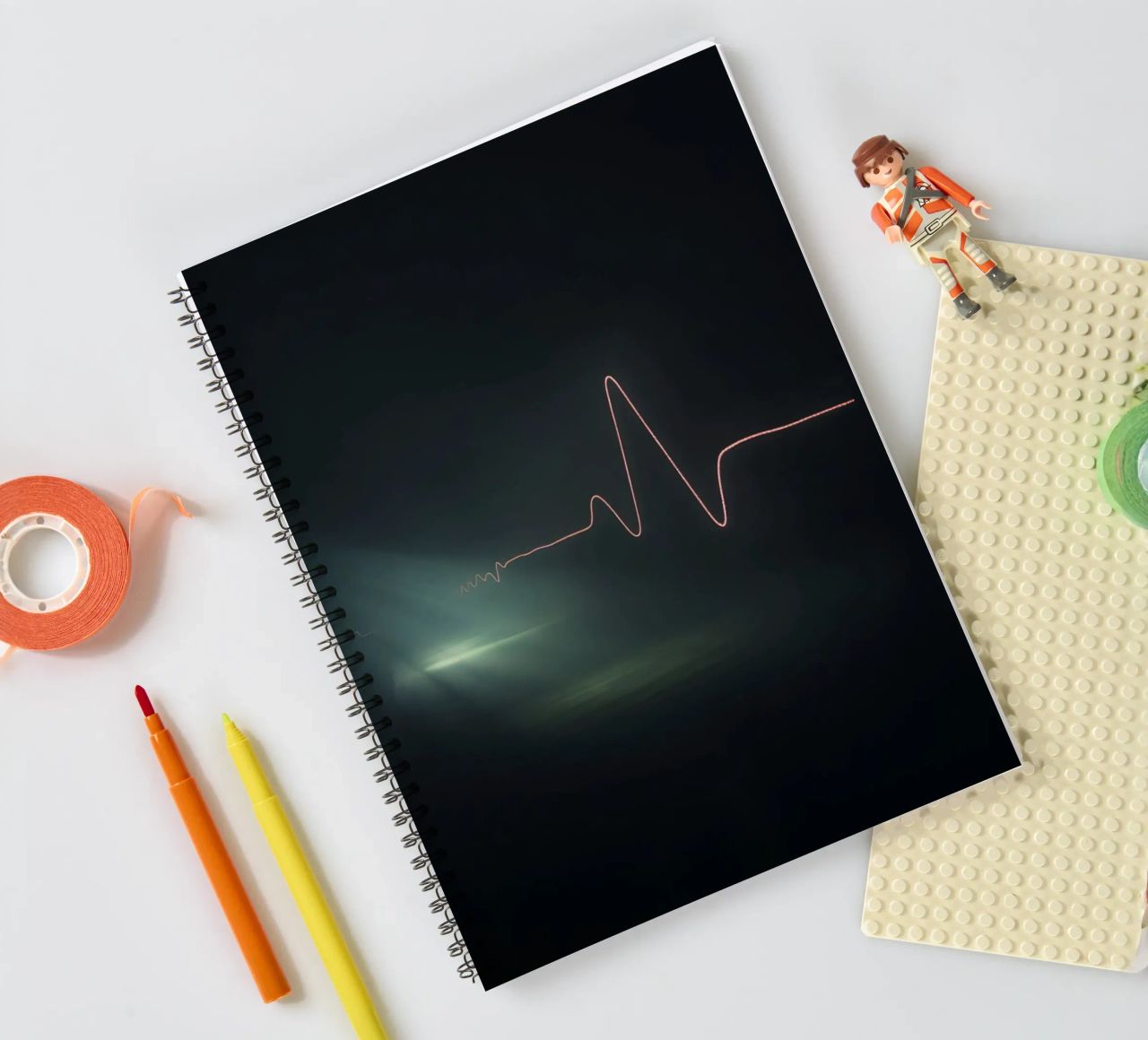 Light trails create a pulse waveform effect in a dark atmos spiral notebook by DesignDoodle
