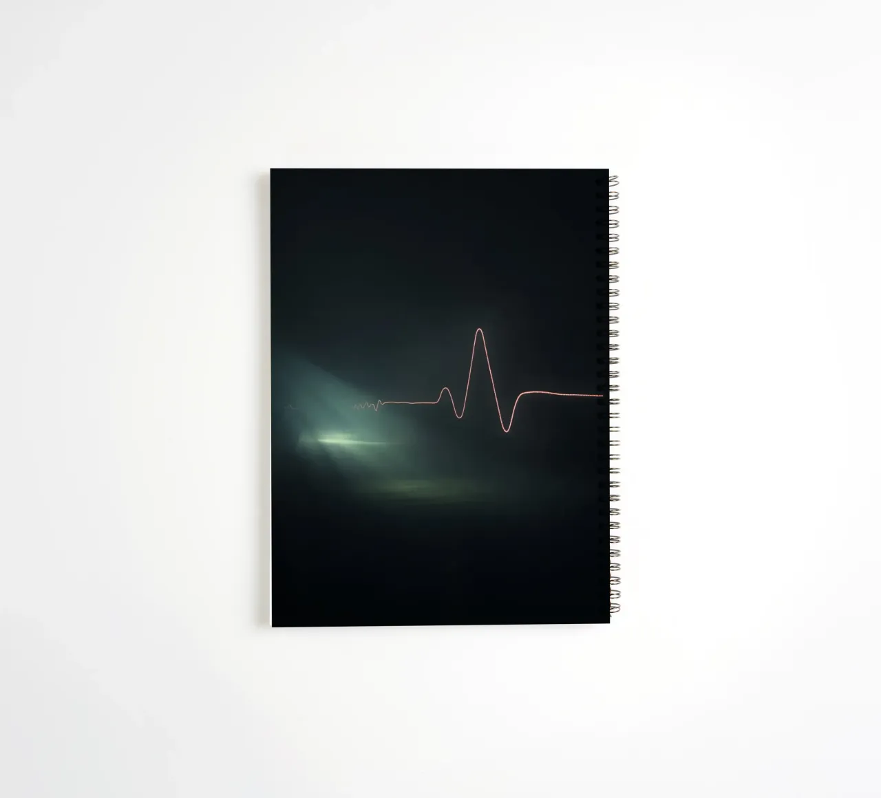 Light trails create a pulse waveform effect in a dark atmos spiral notebook by DesignDoodle