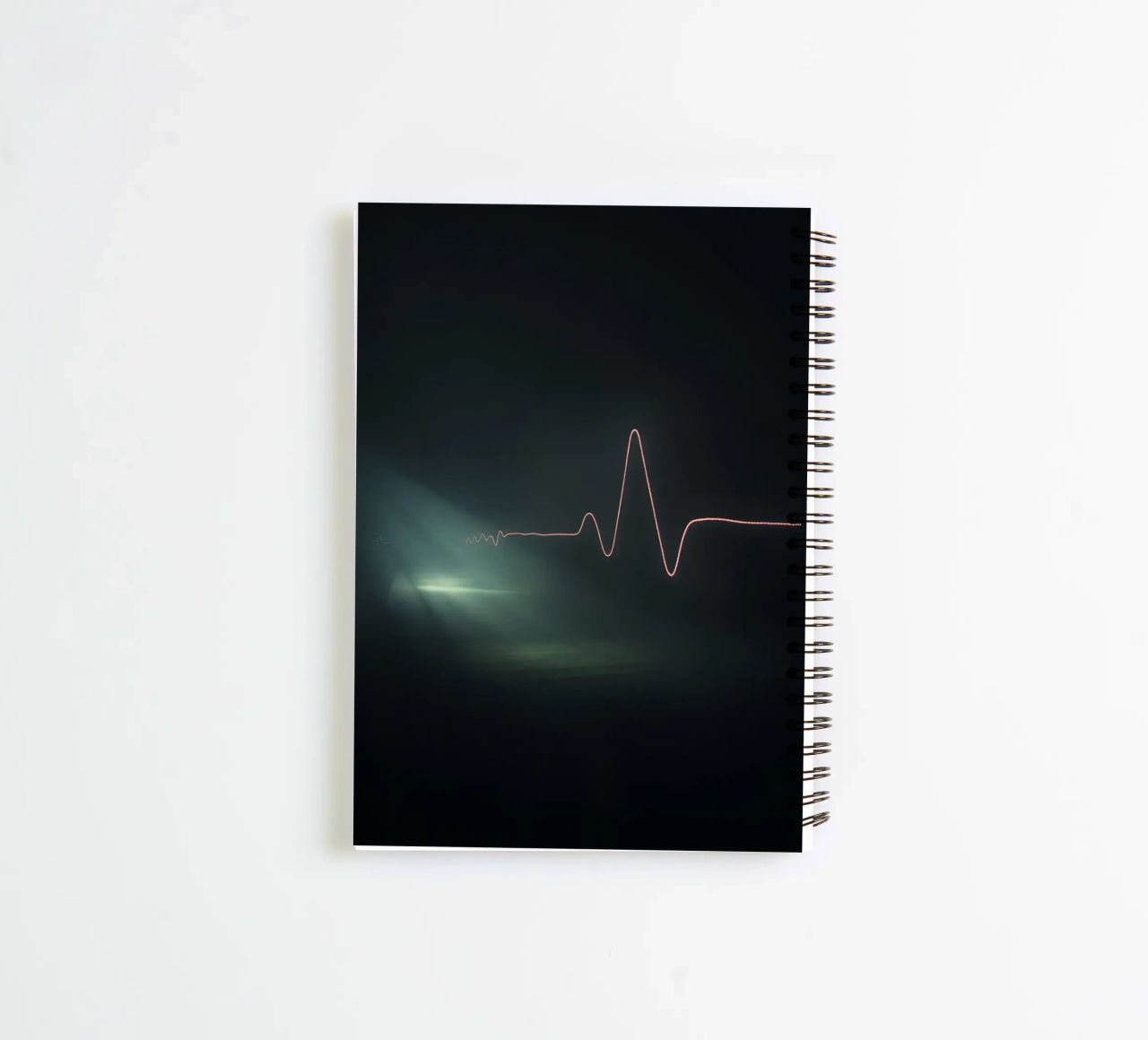 Light trails create a pulse waveform effect in a dark atmos spiral notebook by DesignDoodle