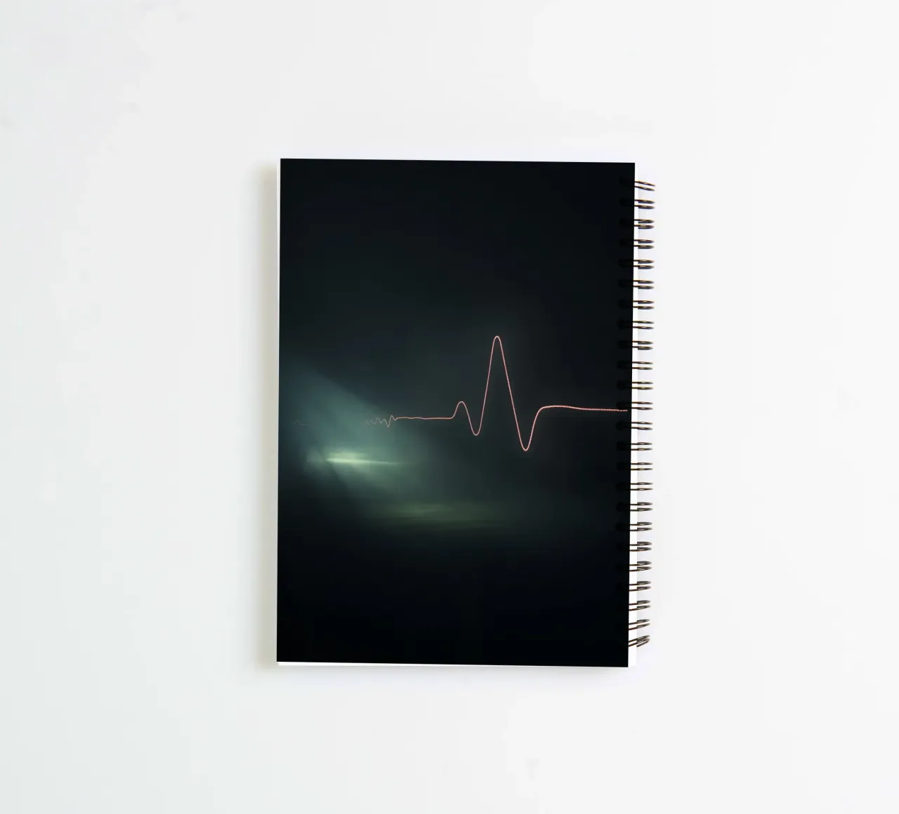 Light trails create a pulse waveform effect in a dark atmos spiral notebook by DesignDoodle
