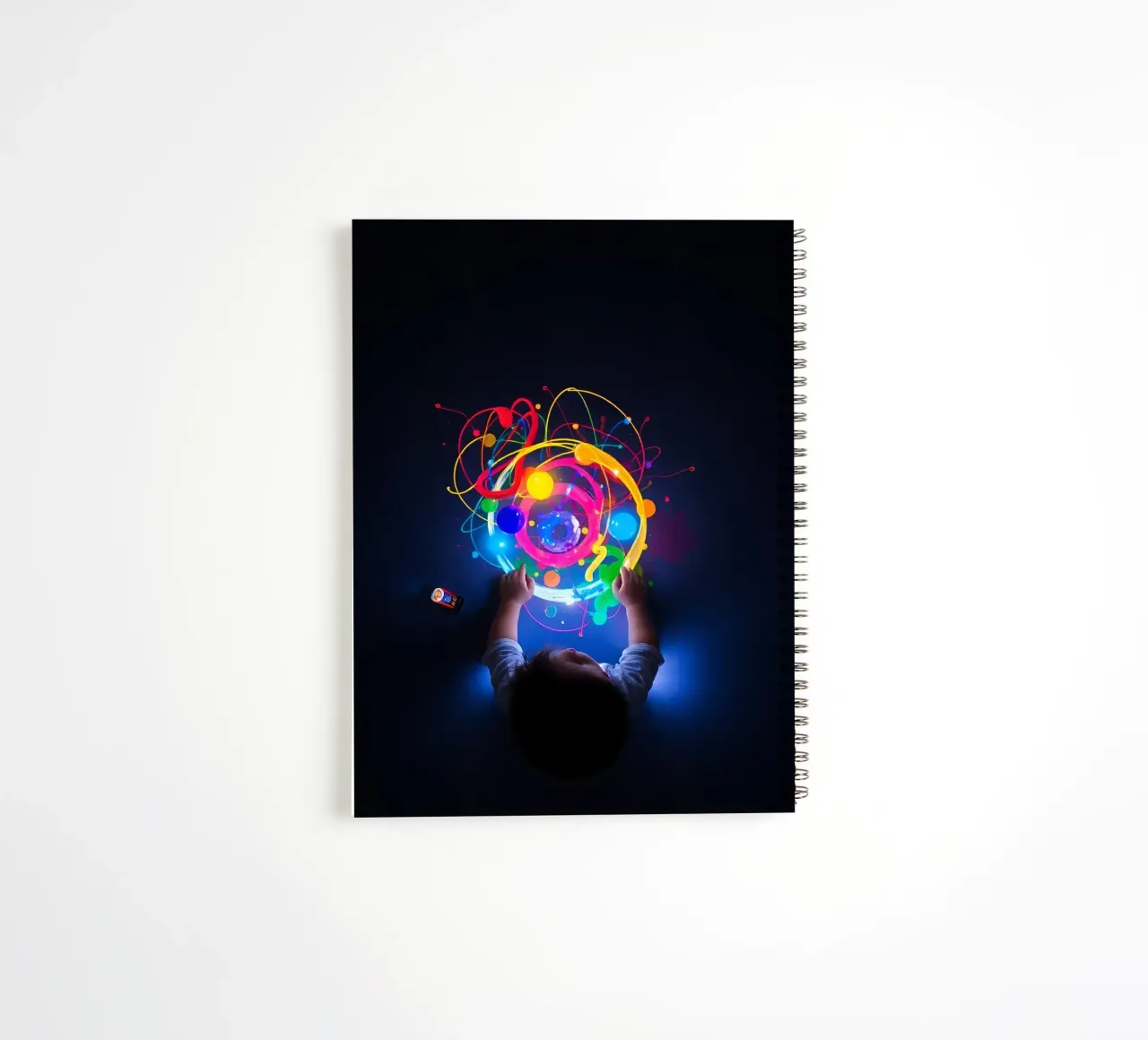 Child exploring colorful visual patterns with hands spiral notebook by DesignDoodle
