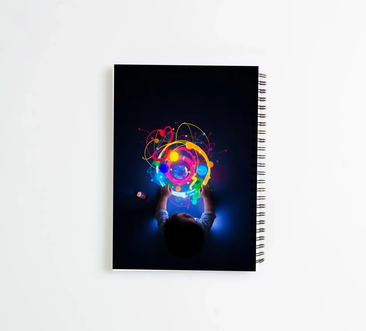 Child exploring colorful visual patterns with hands spiral notebook by DesignDoodle