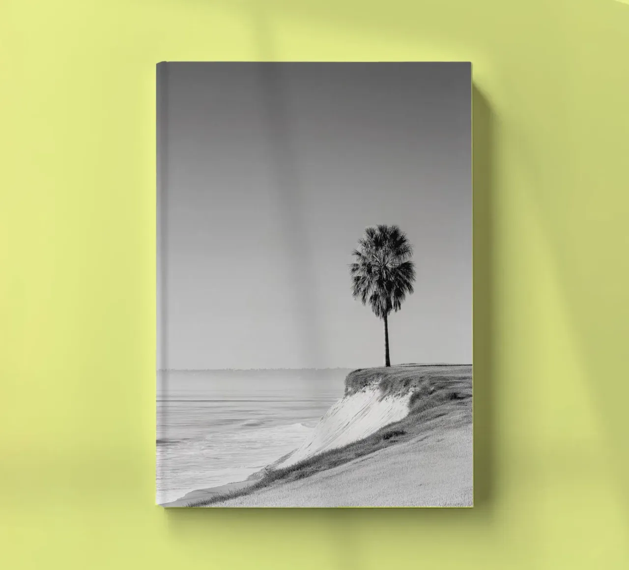 Lone Palm Tree on Coastal Cliff notebook by Indigo Tides Art