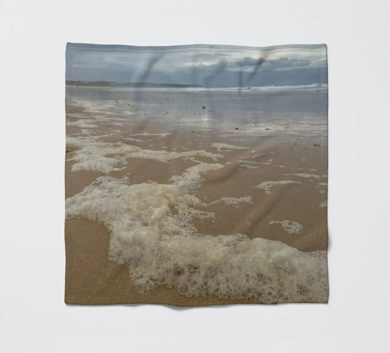 Foam Bubbles under a Cloudy sky at the Beach fleece blanket by byrieneke