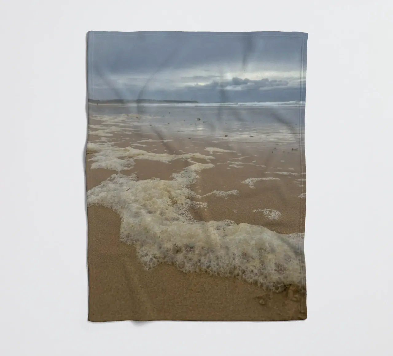 Foam Bubbles under a Cloudy sky at the Beach fleece blanket by byrieneke