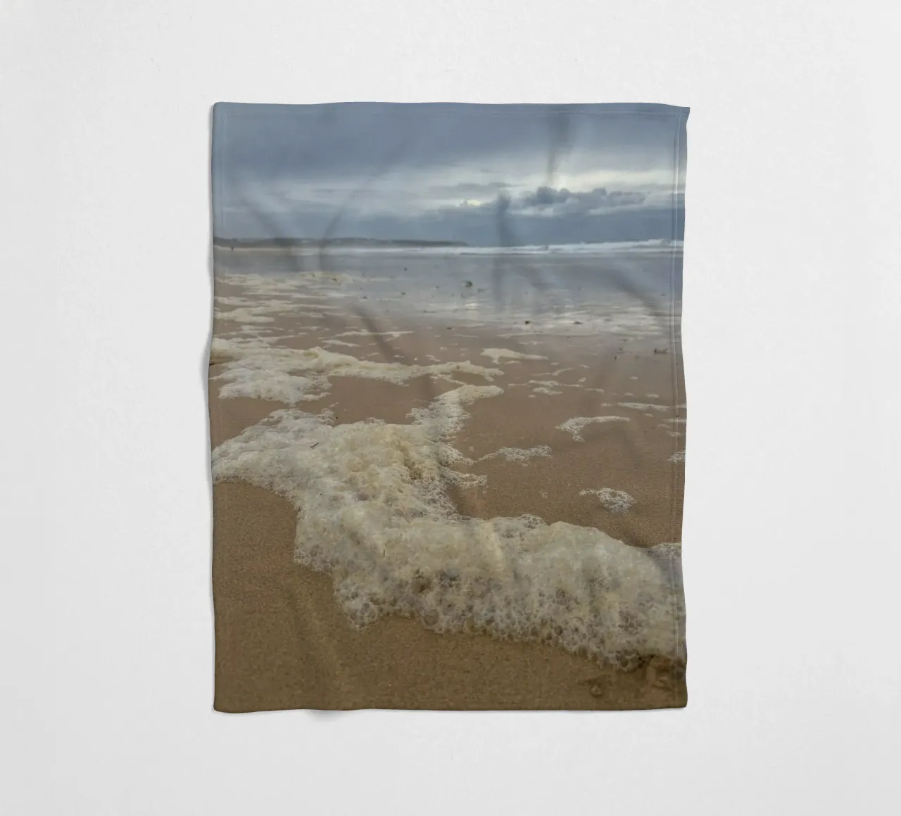 Foam Bubbles under a Cloudy sky at the Beach fleece blanket by byrieneke
