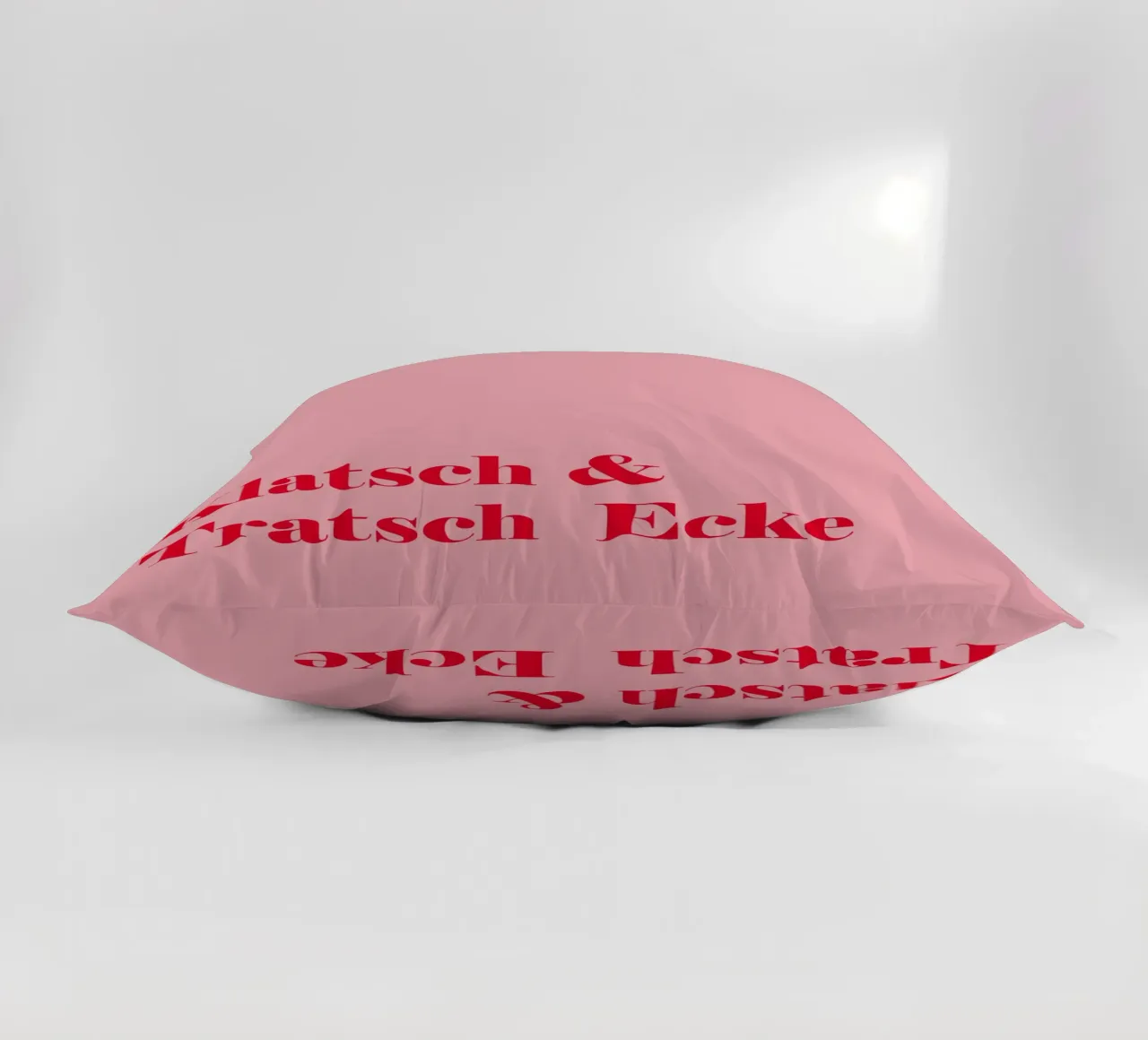 Gossip corner in raspberry red on pink for summer decorative cushion by Stilrausch