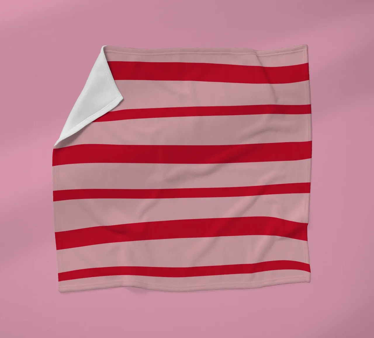 Diagonal hand-painted lines in strawberry red on pink fleece blanket by Stilrausch