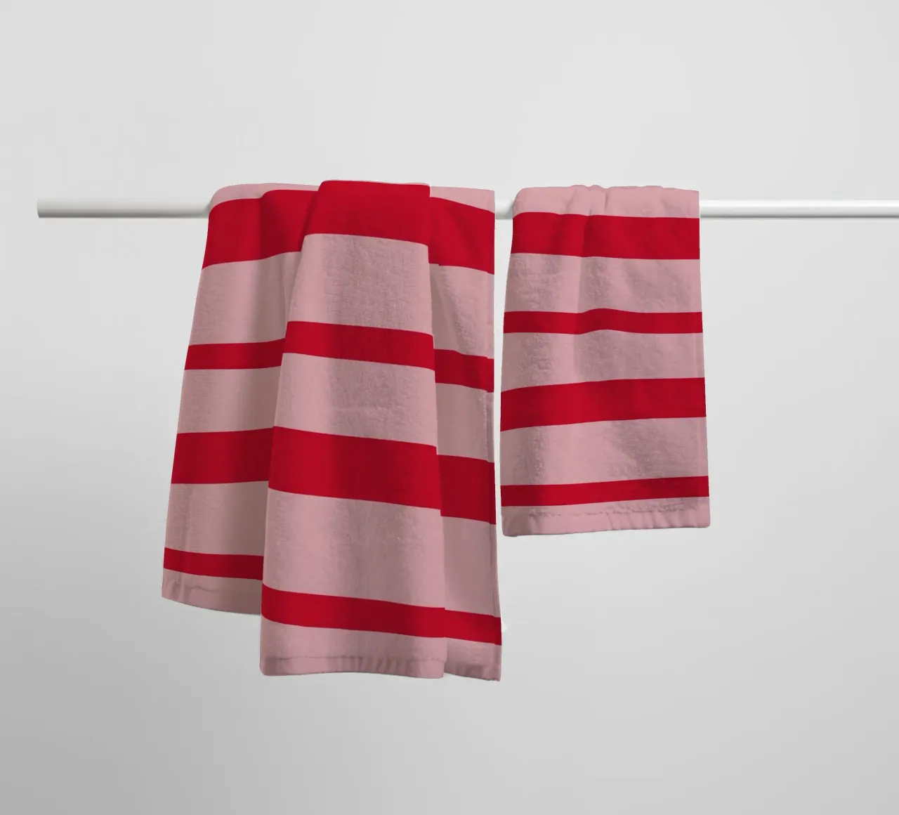 Horizontal hand-painted lines in strawberry red on pink towel by Stilrausch