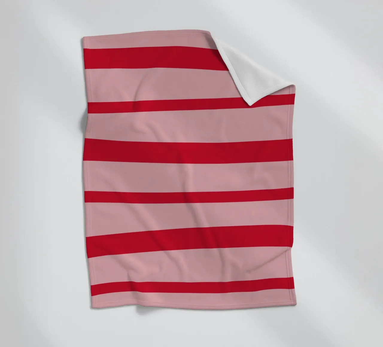Horizontal hand-painted lines in strawberry red on pink fleece blanket by Stilrausch