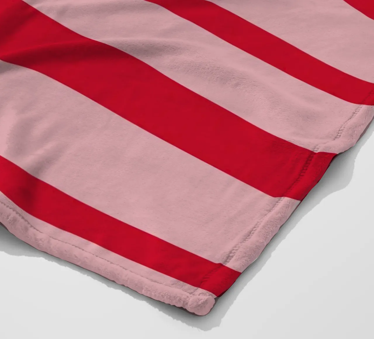 Horizontal hand-painted lines in strawberry red on pink fleece blanket by Stilrausch