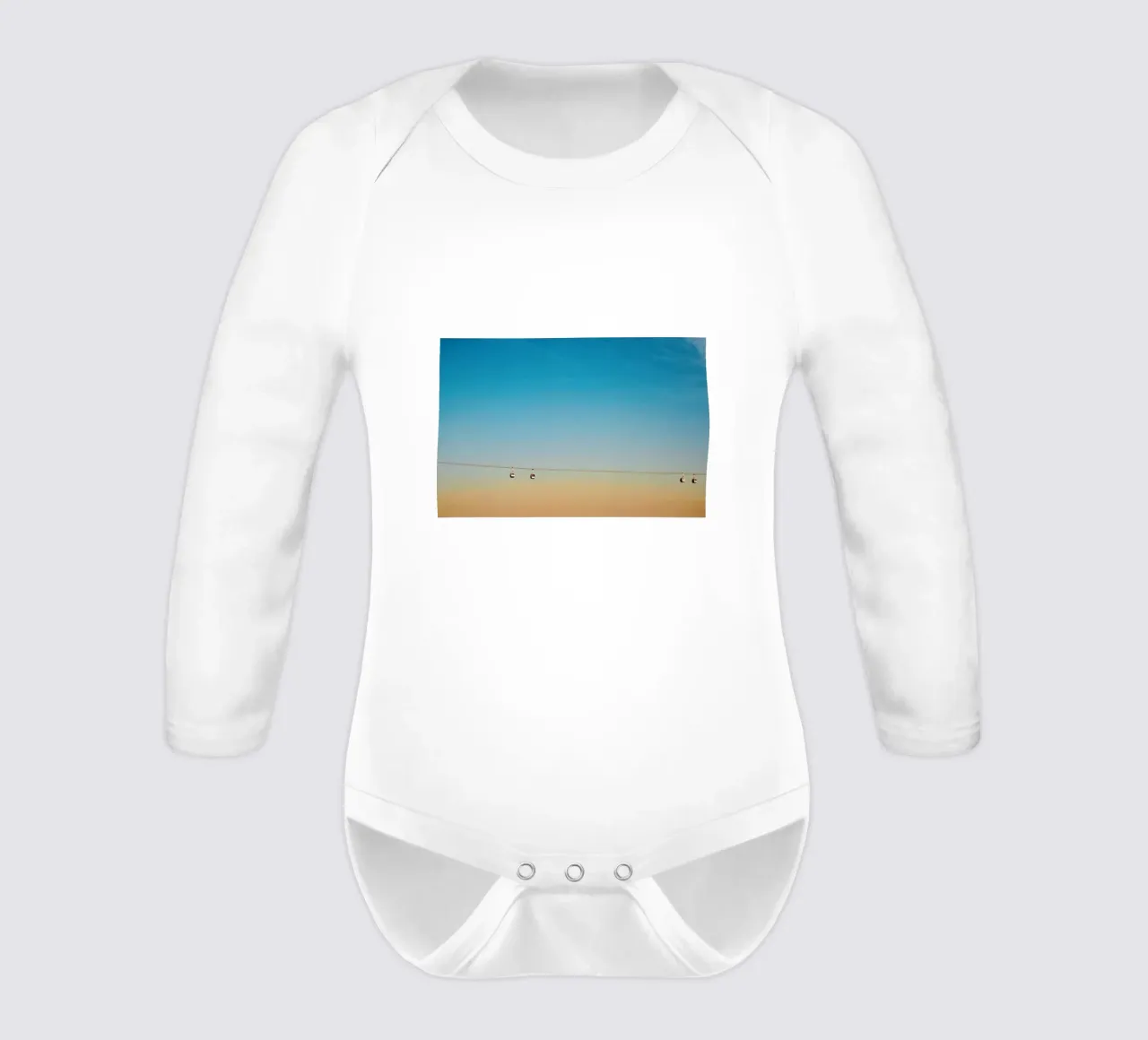 Cable Cars in Orange Sunset long-sleeve baby romper by KISSA STUDIO