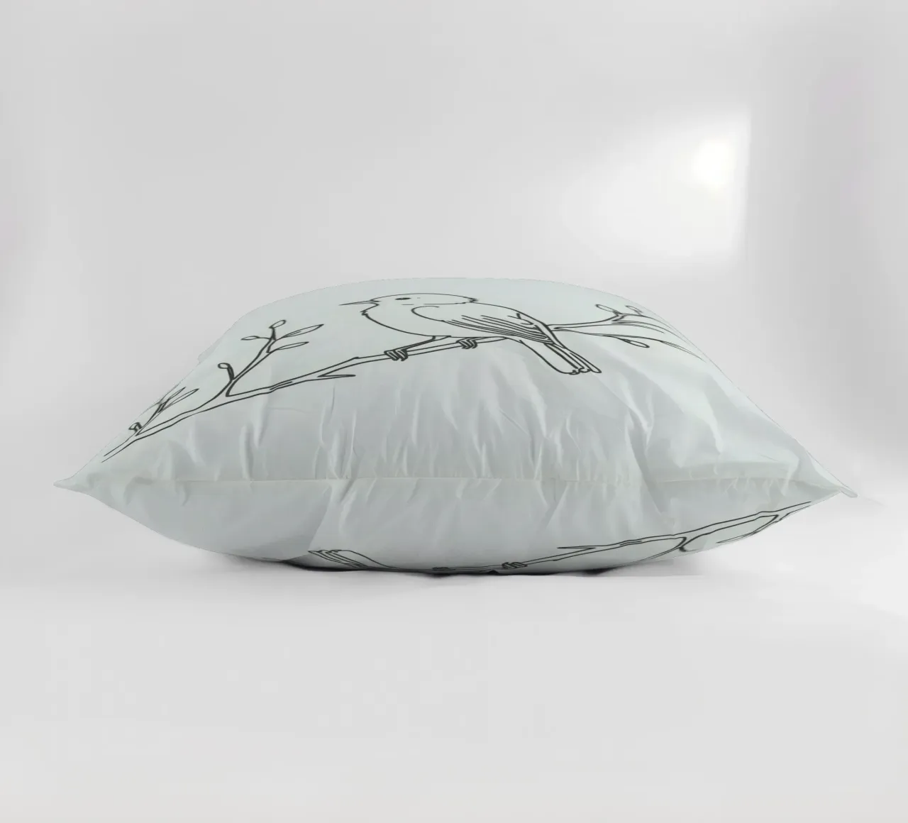 Uccello appollaiato su un ramo con foglie delicate cuscino da DesignDoodle
