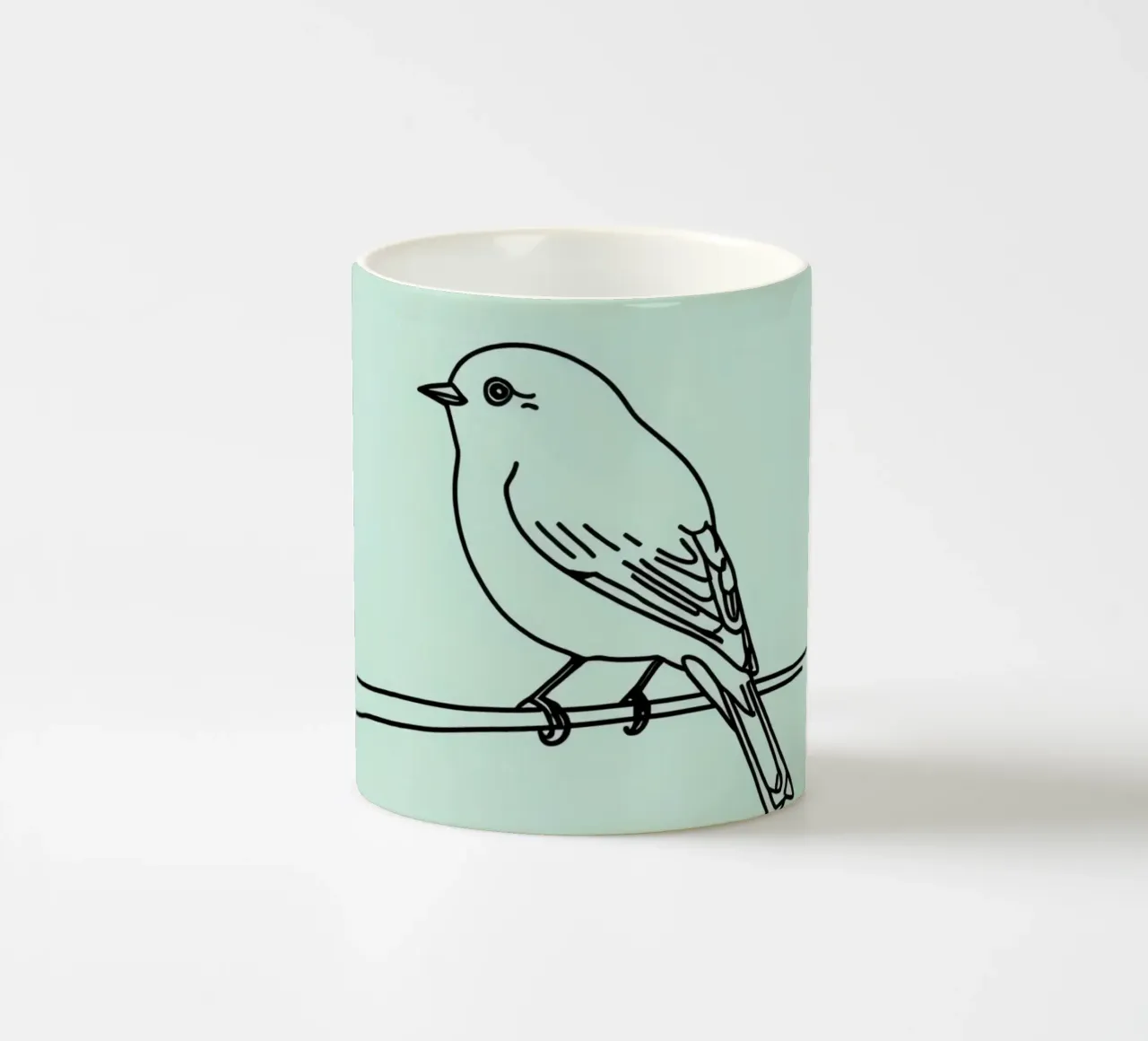un piccolo uccello appollaiato su un ramo sfondo verde chiaro tazza in ceramica da DesignDoodle