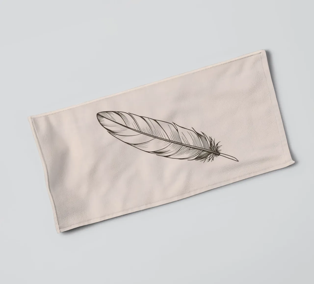 Delicate black feather resting on a light background towel by DesignDoodle