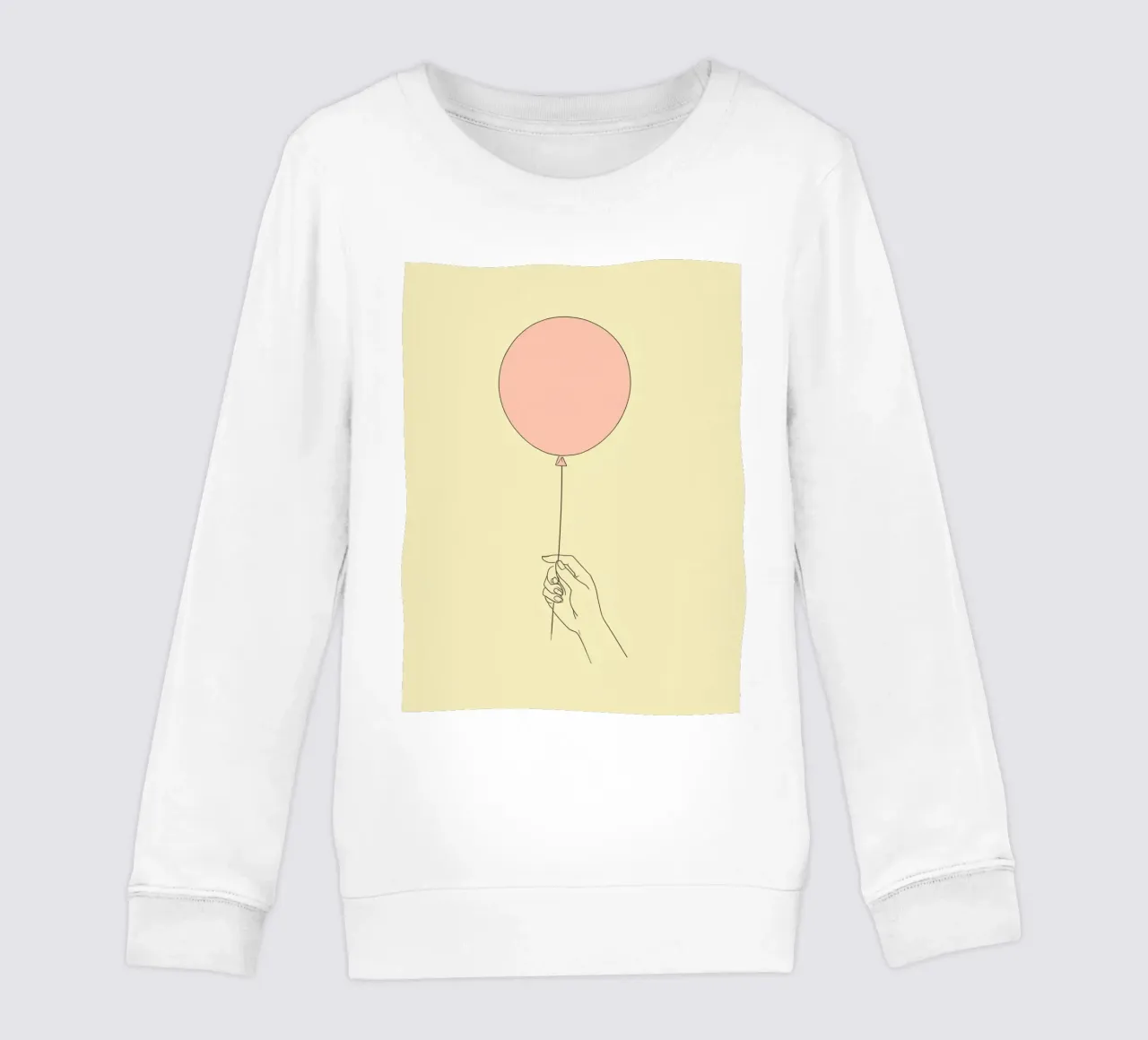 Mano che tiene un palloncino rosa su un'opera d'arte giallo tenue felpa bambino da DesignDoodle